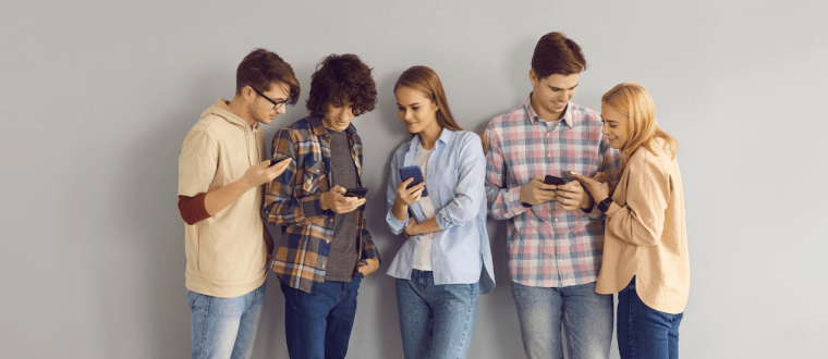 Five young people looking into their phone 